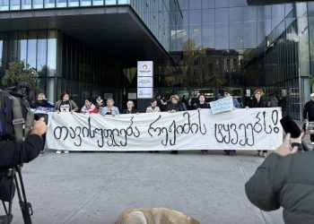 აქციებზე დაკავებული პატიმრების ოჯახის წევრებმა იუსტიციის სახლთან ბანერი გაშალეს